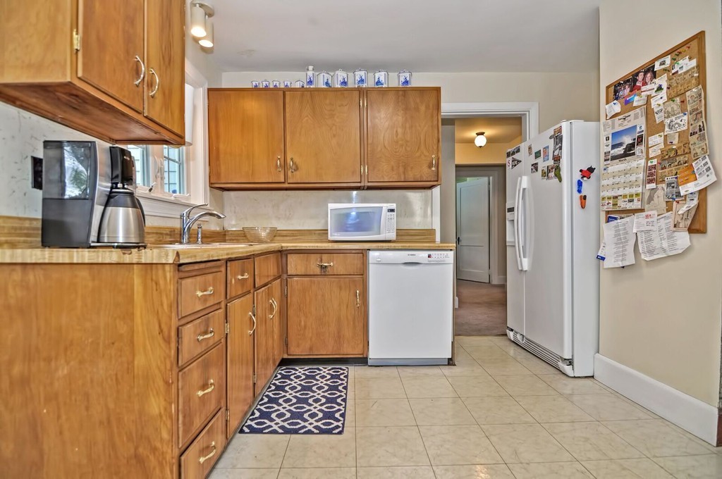 35 July Road Sudbury, MA 01776 - Photo 10 of 24 a kitchen with stainless steel appliances a sink a stove a refrigerator and cabinets