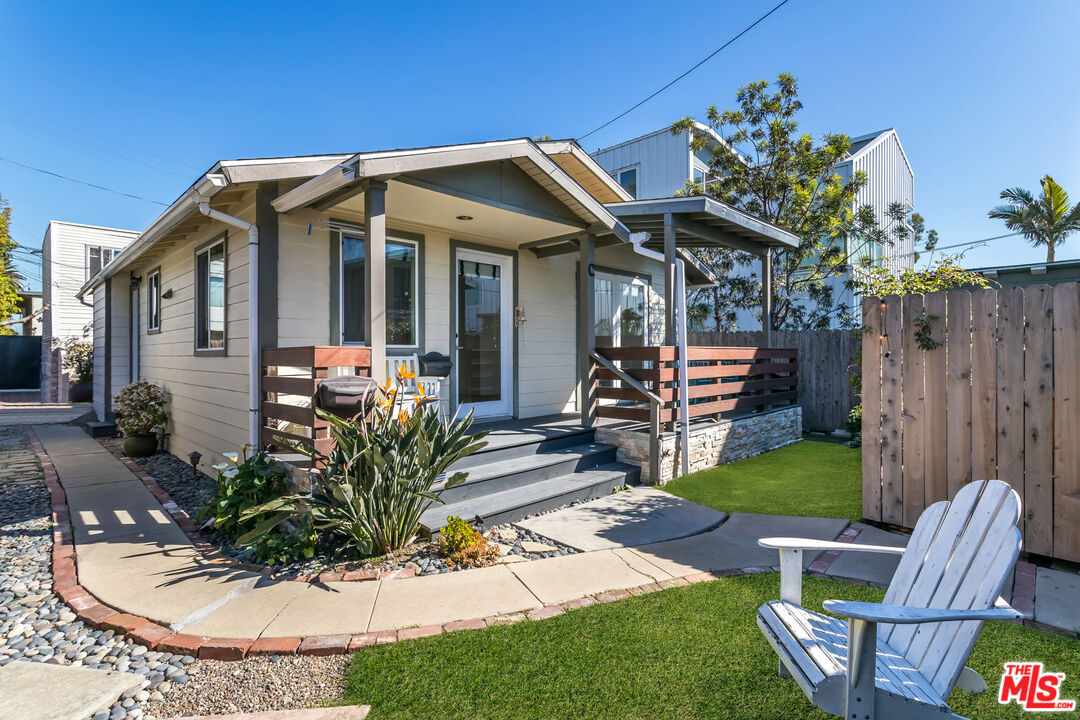 a view of a house with backyard water fountain and sitting area