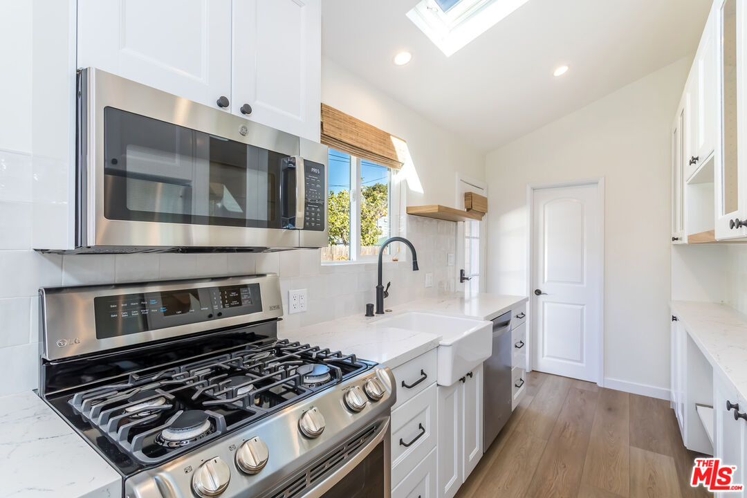 336 Rennie Avenue, Unit C Venice, CA 90291 - Photo 11 of 23 a kitchen with stainless steel appliances granite countertop a stove and a sink