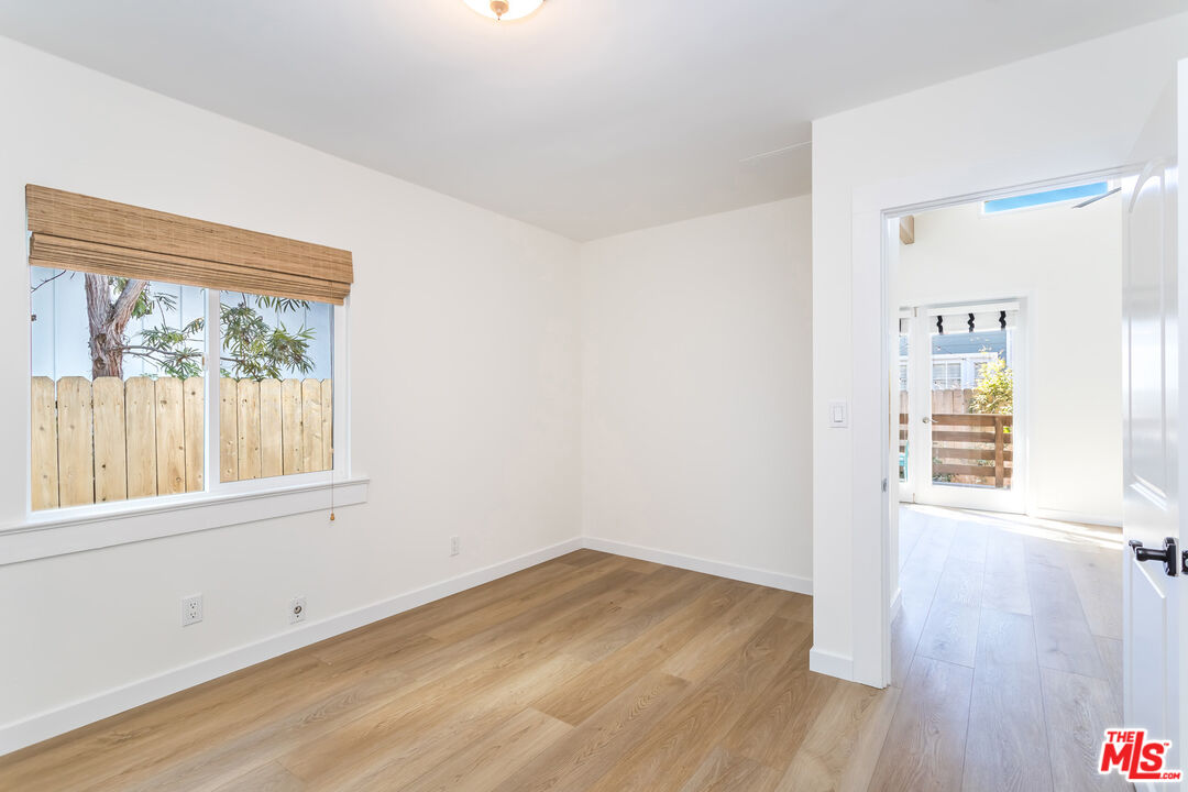 336 Rennie Avenue, Unit C Venice, CA 90291 - Photo 13 of 23 an empty room with wooden floor and a window