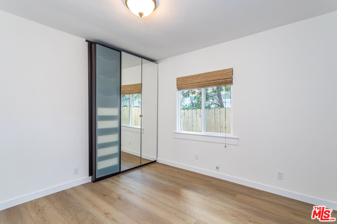 336 Rennie Avenue, Unit C Venice, CA 90291 - Photo 14 of 23 an empty room with wooden floor and windows