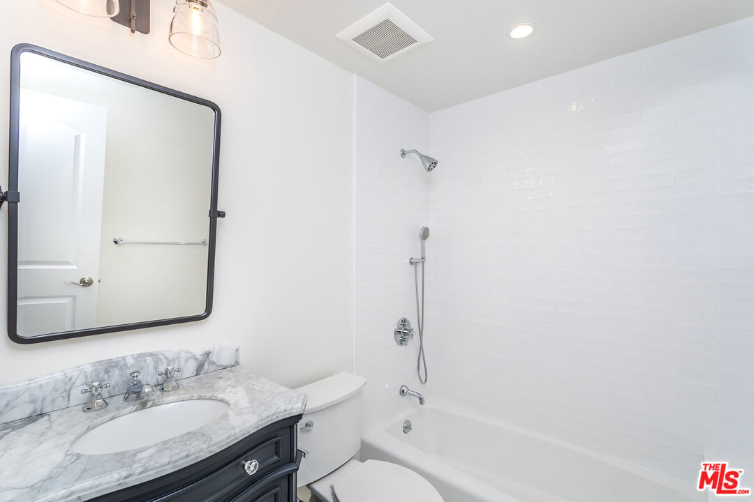 336 Rennie Avenue, Unit C Venice, CA 90291 - Photo 15 of 23 a bathroom with a granite countertop sink mirror toilet and bathtub