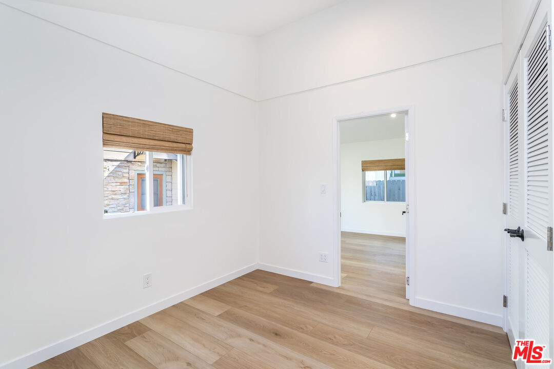 336 Rennie Avenue, Unit C Venice, CA 90291 - Photo 17 of 23 an empty room with wooden floor and windows