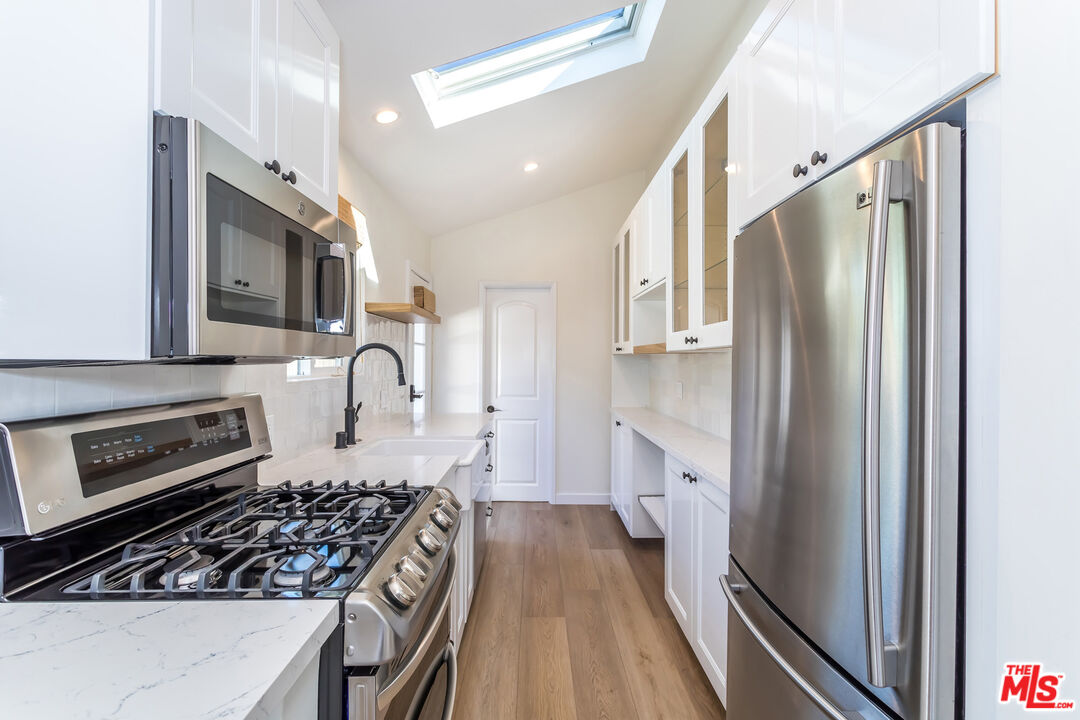 336 Rennie Avenue, Unit C Venice, CA 90291 - Photo 10 of 23 a kitchen with stainless steel appliances granite countertop a stove a refrigerator and a stove