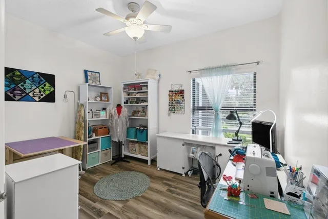 a view of a workspace with furniture and a window