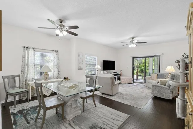 a living room with furniture a window and a flat screen tv