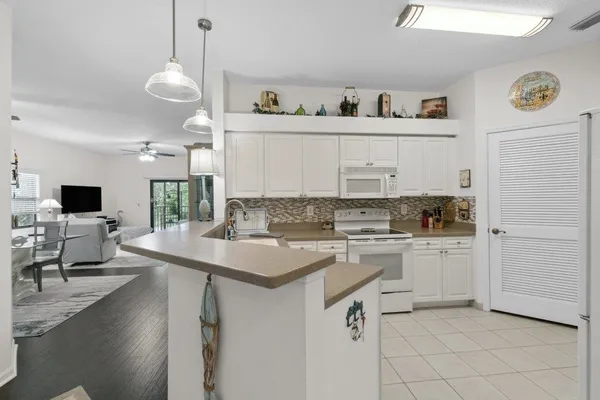 a kitchen with a sink cabinets and window