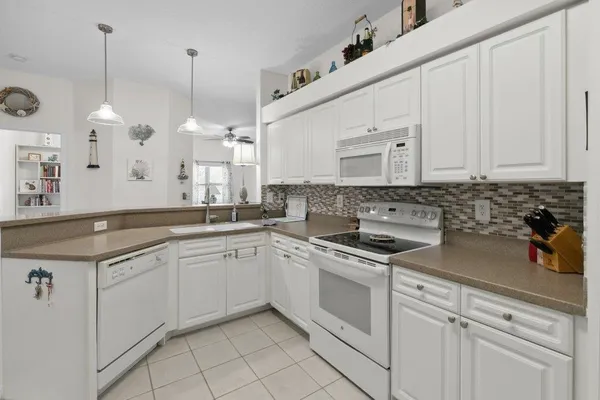 a kitchen with a sink stove and cabinets