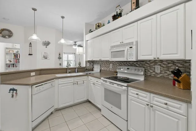 a kitchen with a sink stove and cabinets