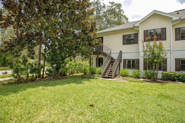a view of a house with a yard and plants