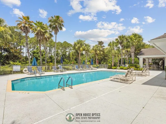 a view of swimming pool with outdoor seating and plants