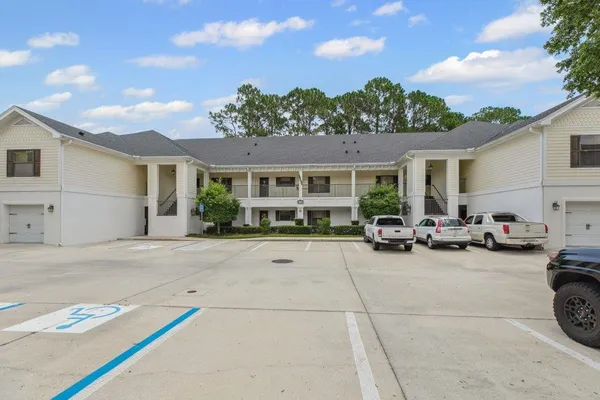 a view of a patio with table and chairs with wooden fence