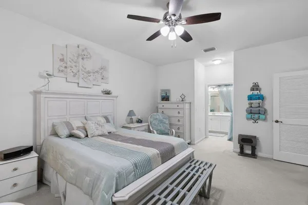 a bedroom with bed and a chandelier