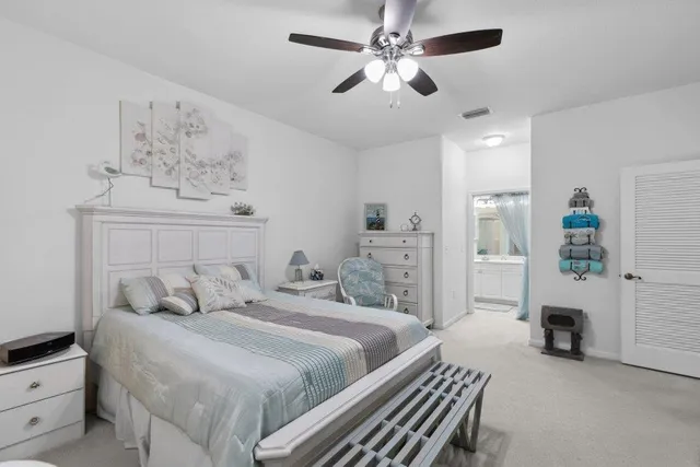 a bedroom with bed and a chandelier