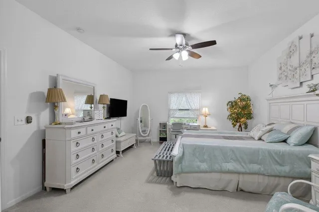 a bedroom with a large bed and a tv