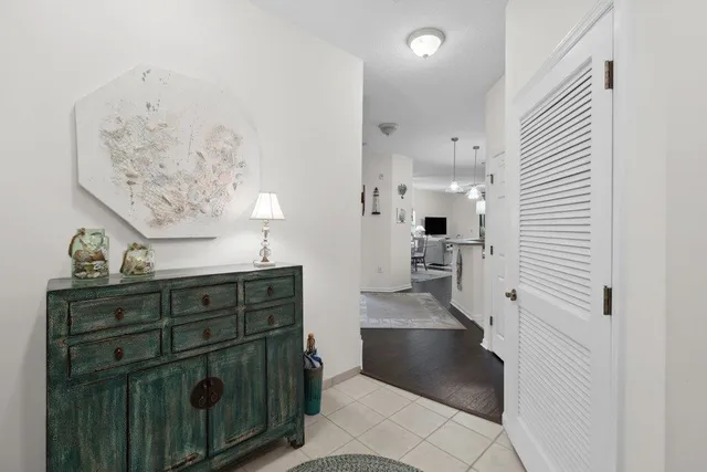 a view of a hallway and a mirror on a dresser