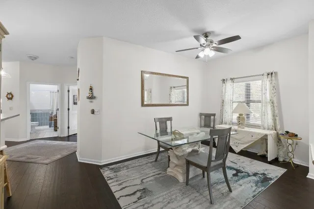 a view of a livingroom with furniture and a dining table