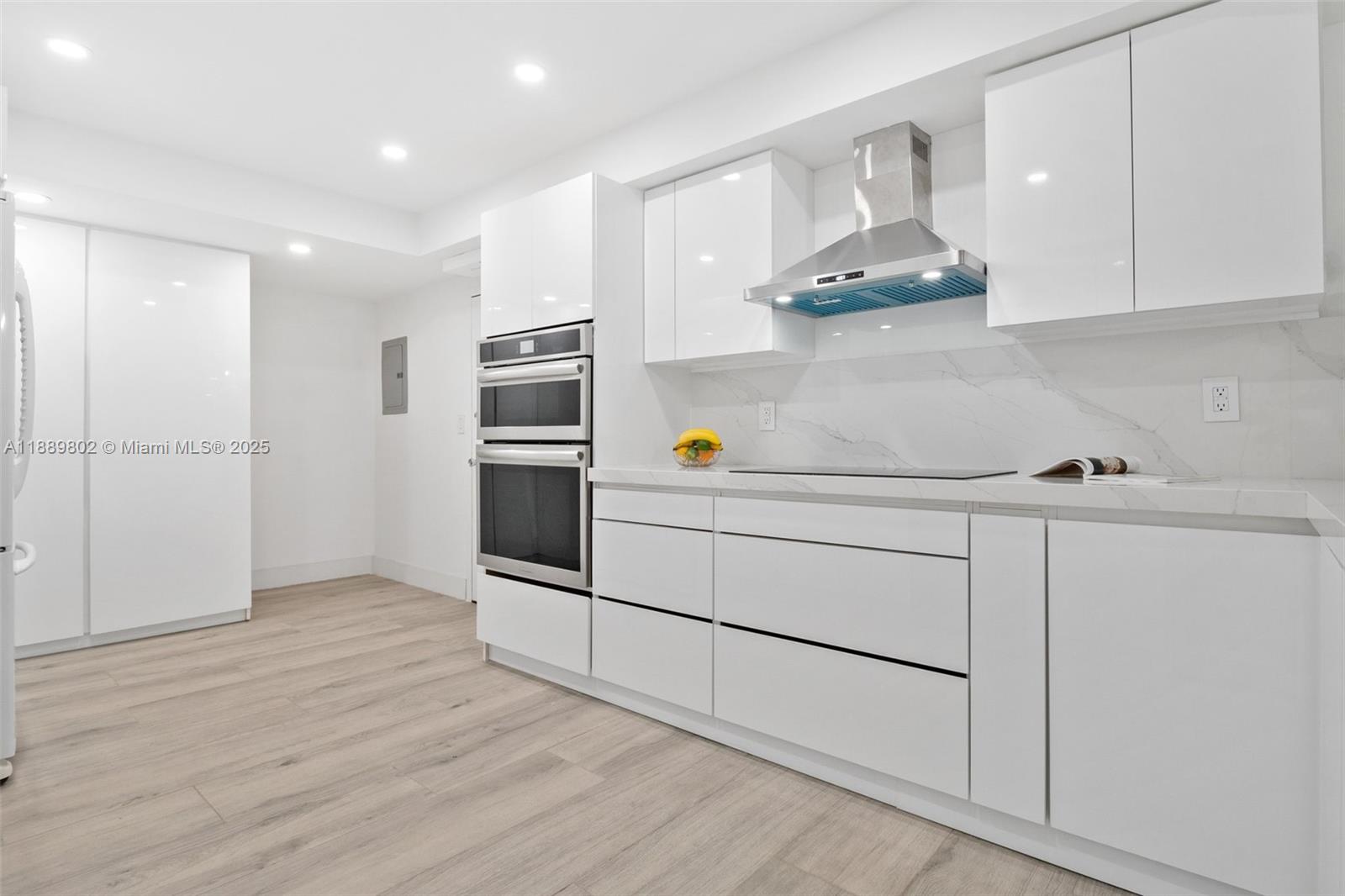 1121 Crandon Boulevard, Unit D304 Key Biscayne, FL 33149 - Photo 11 of 42 a kitchen with stainless steel appliances a refrigerator and cabinets