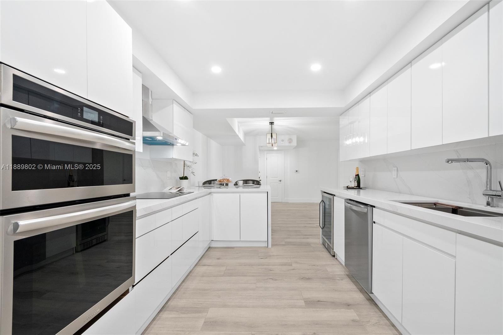 1121 Crandon Boulevard, Unit D304 Key Biscayne, FL 33149 - Photo 12 of 42 a kitchen with granite countertop cabinets stainless steel appliances and sink