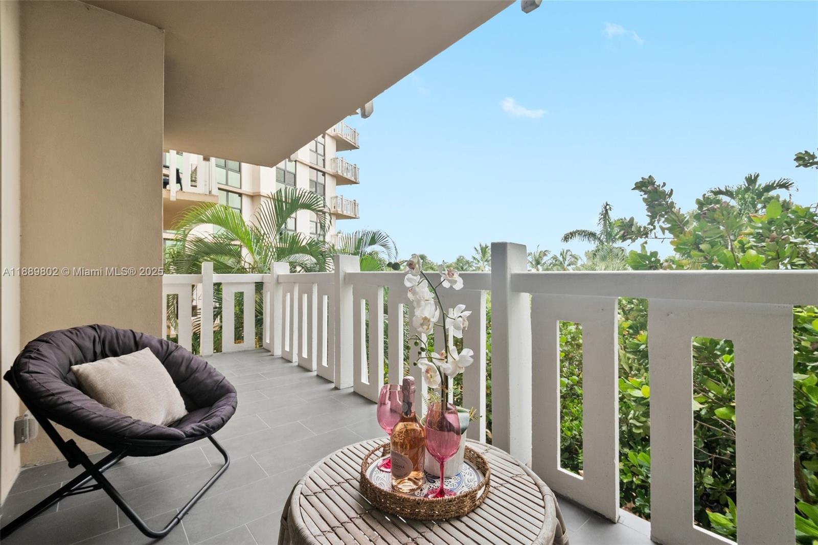 1121 Crandon Boulevard, Unit D304 Key Biscayne, FL 33149 - Photo 2 of 42 a balcony with chairs and a potted plant