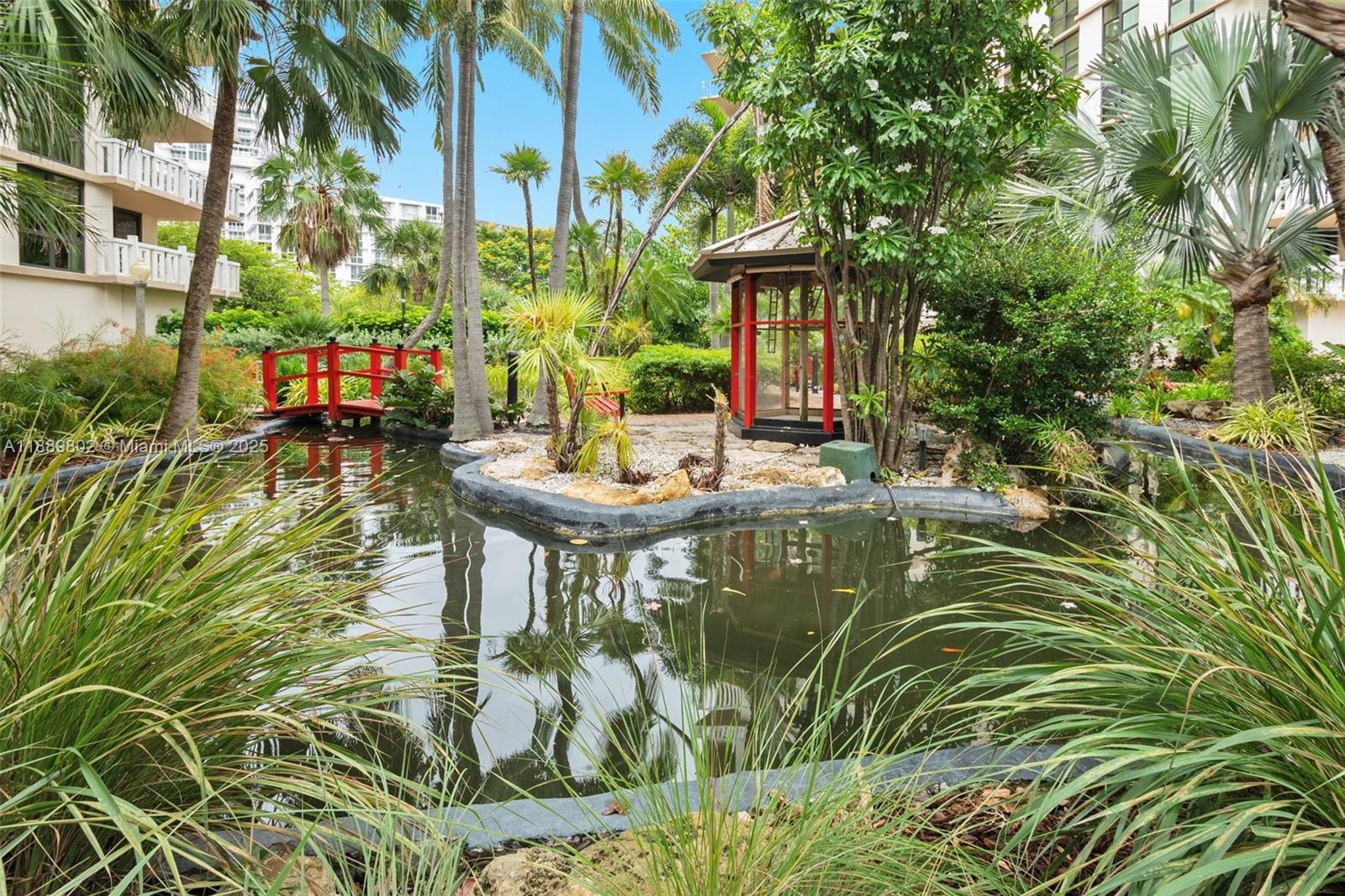 1121 Crandon Boulevard, Unit D304 Key Biscayne, FL 33149 - Photo 21 of 42 a backyard of a house with fountain table and chairs