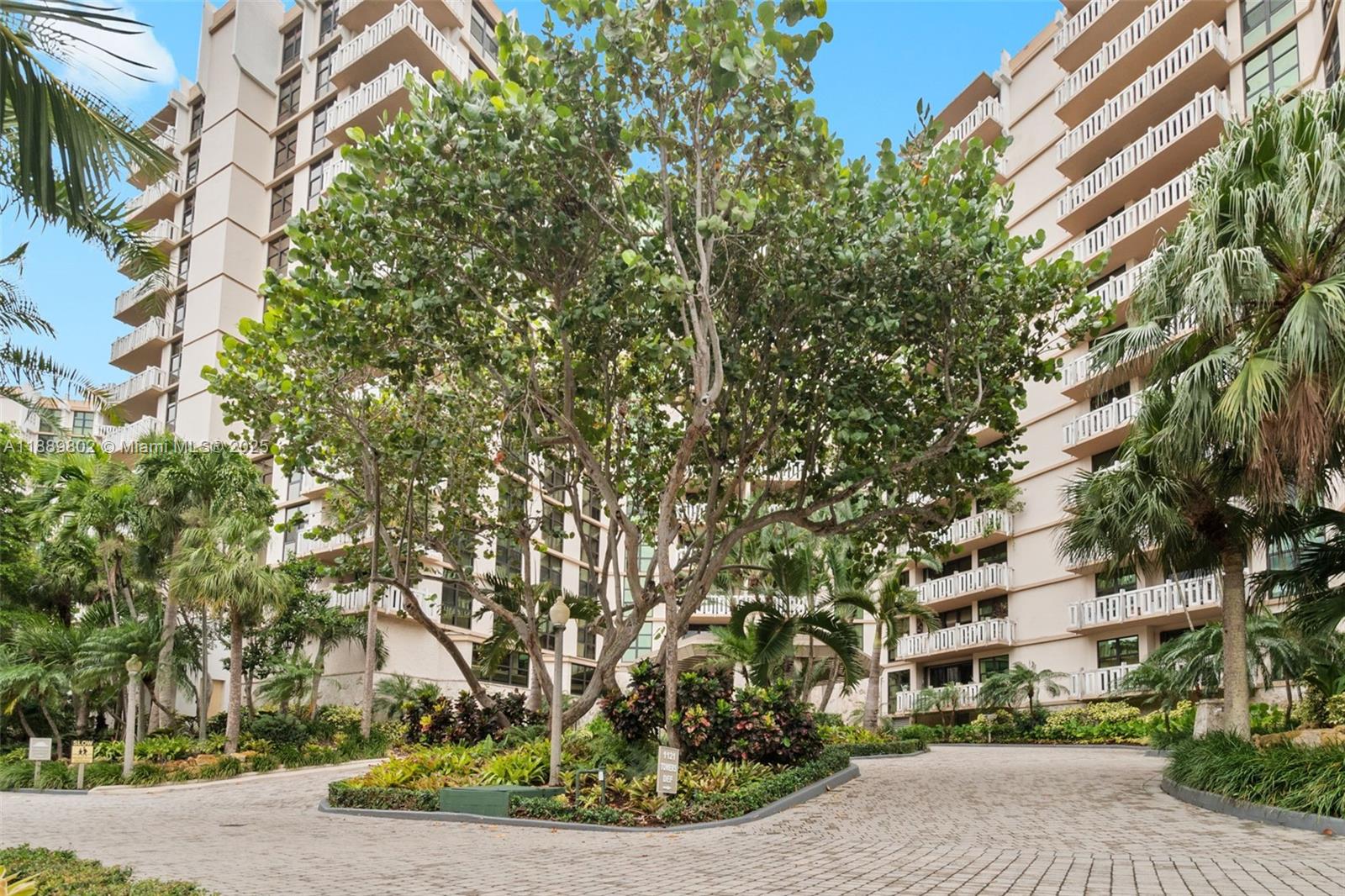 1121 Crandon Boulevard, Unit D304 Key Biscayne, FL 33149 - Photo 23 of 42 a front view of a house with a yard