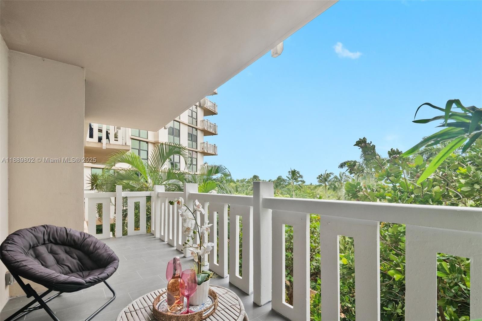 1121 Crandon Boulevard, Unit D304 Key Biscayne, FL 33149 - Photo 26 of 42 a outdoor living space with furniture and garden view