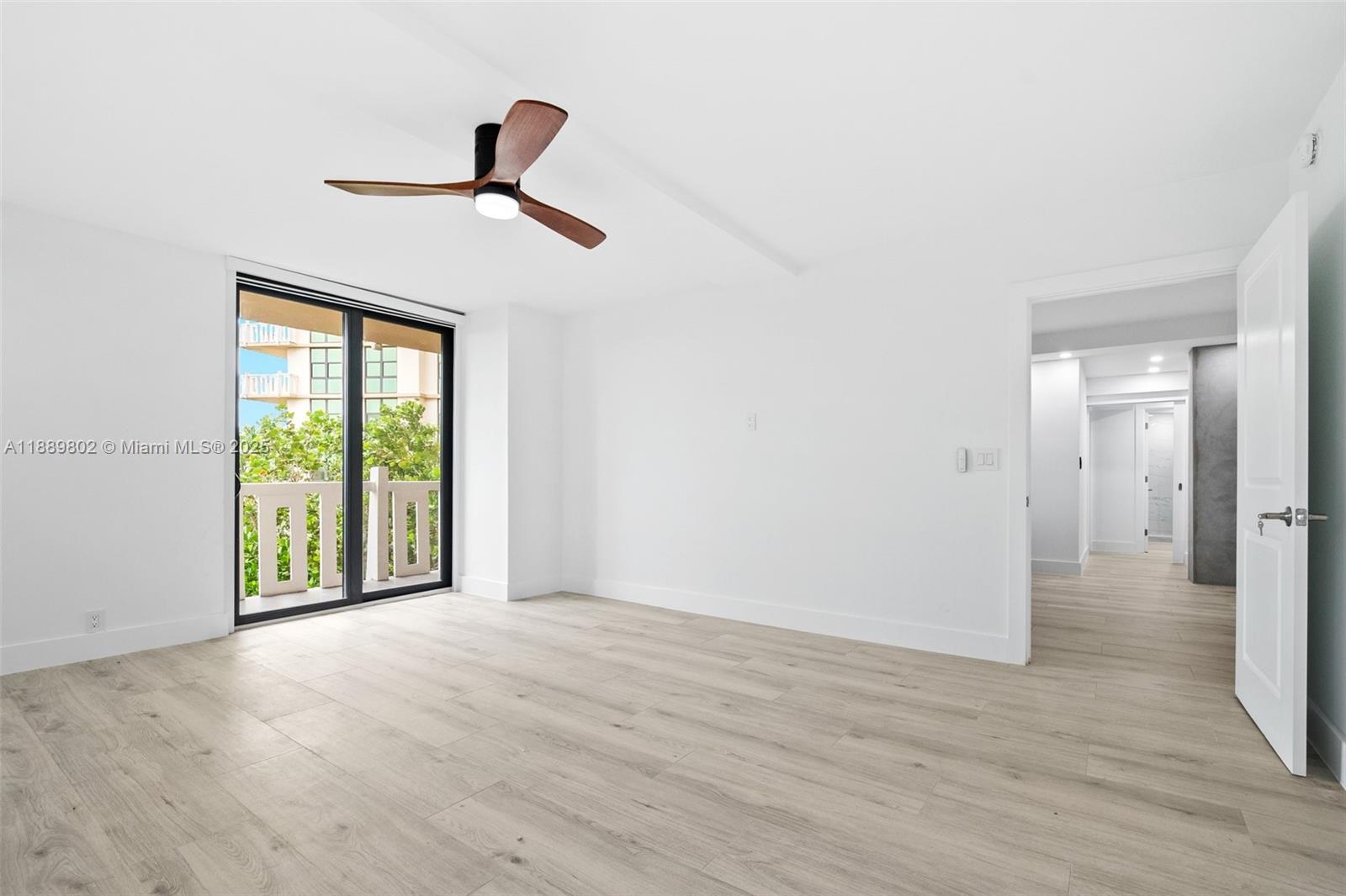 1121 Crandon Boulevard, Unit D304 Key Biscayne, FL 33149 - Photo 28 of 42 a view of empty room with wooden floor and fan