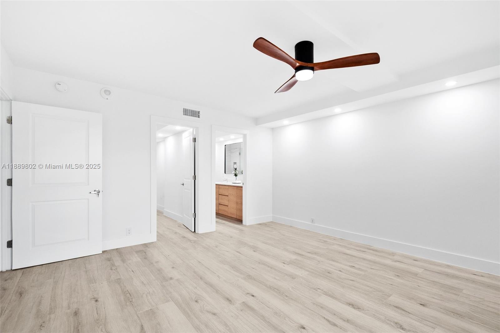 1121 Crandon Boulevard, Unit D304 Key Biscayne, FL 33149 - Photo 29 of 42 a view of empty room with wooden floor and ceiling fan