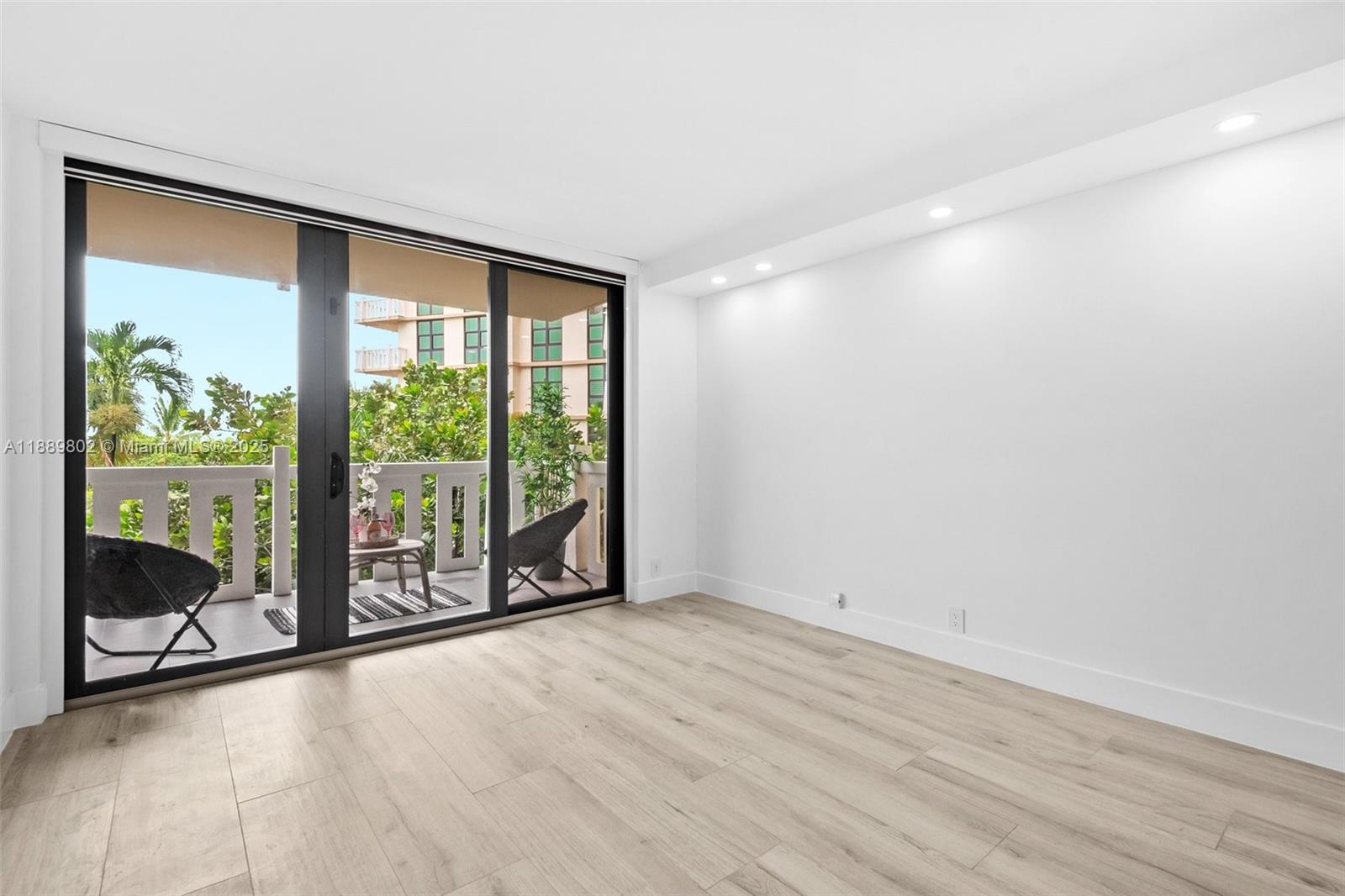 1121 Crandon Boulevard, Unit D304 Key Biscayne, FL 33149 - Photo 36 of 42 a view of an empty room with wooden floor and a window