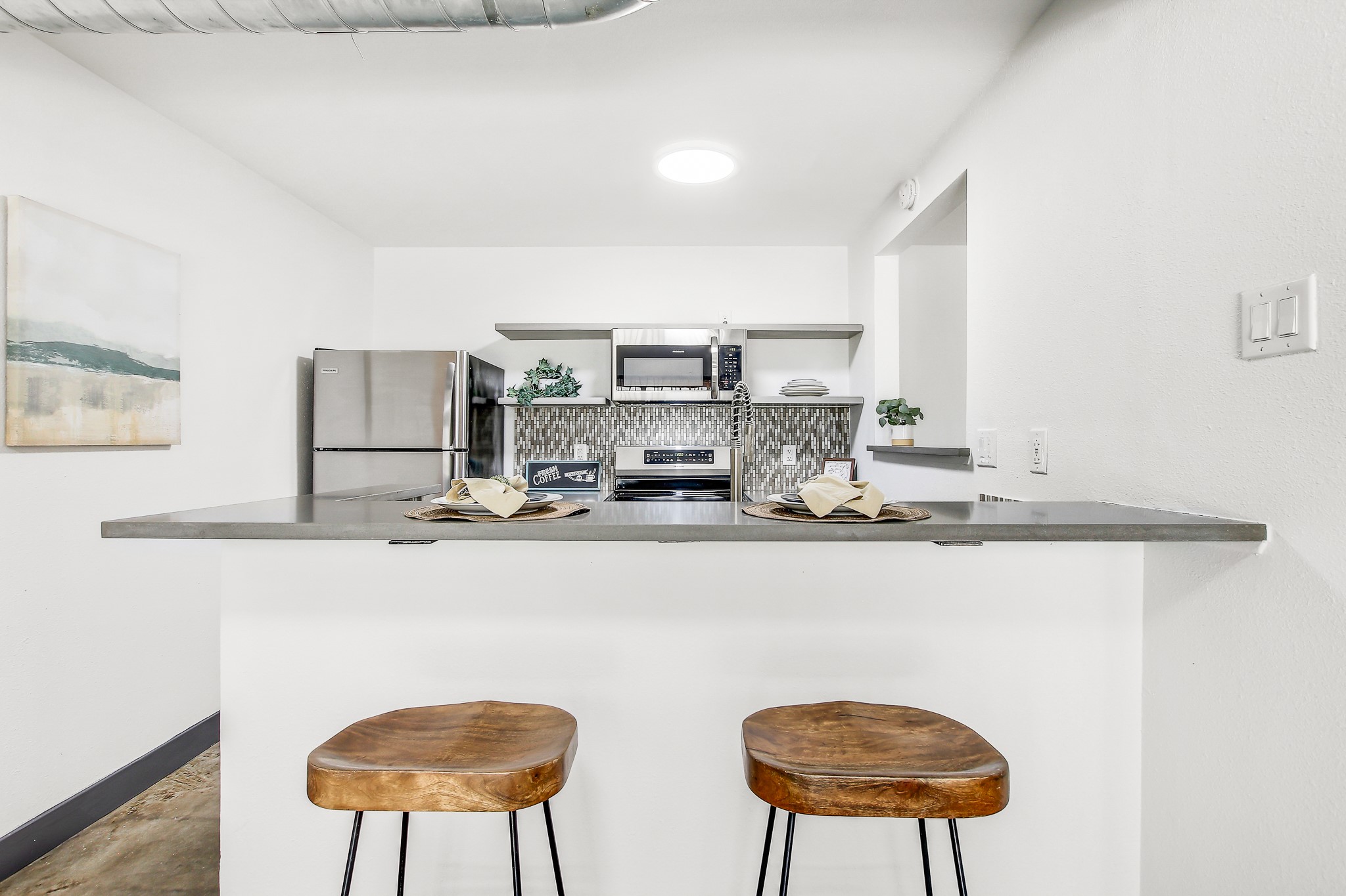 2124 Burton Drive, Unit 164 Austin, TX 78741 - Photo 11 of 37 a kitchen with stainless steel appliances a dining table chairs and a refrigerator