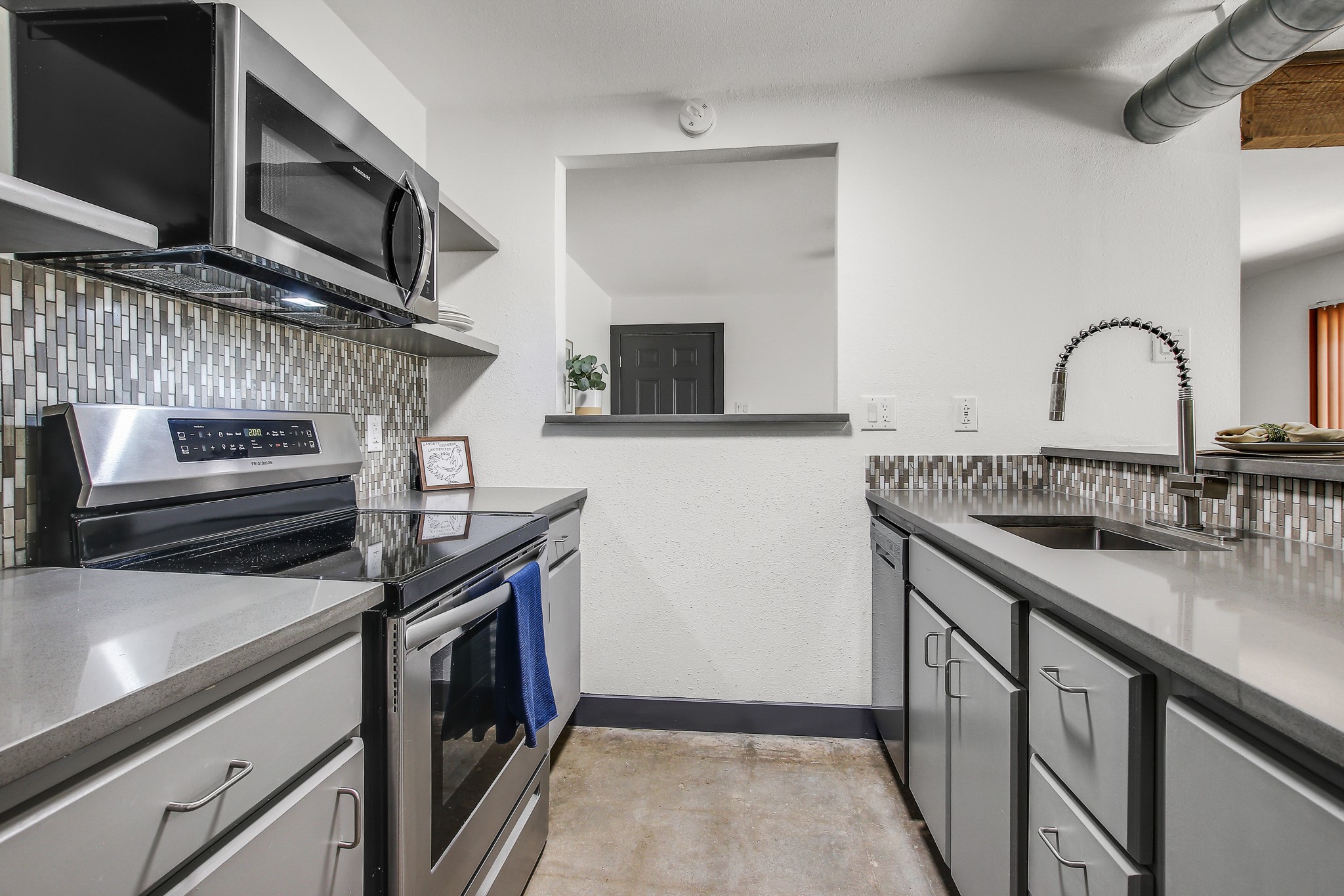 2124 Burton Drive, Unit 164 Austin, TX 78741 - Photo 12 of 37 a kitchen with stainless steel appliances granite countertop a stove and a sink