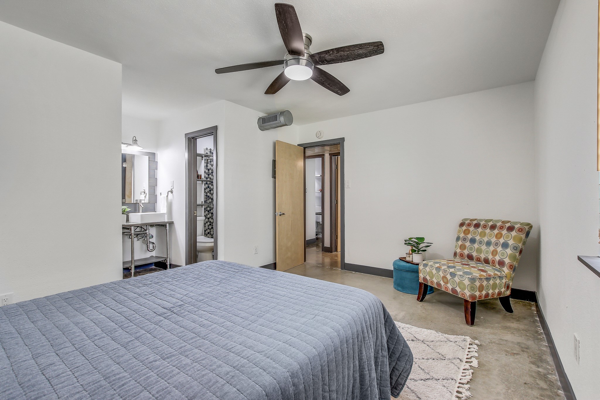 2124 Burton Drive, Unit 164 Austin, TX 78741 - Photo 17 of 37 a bedroom with a bed and a chandelier