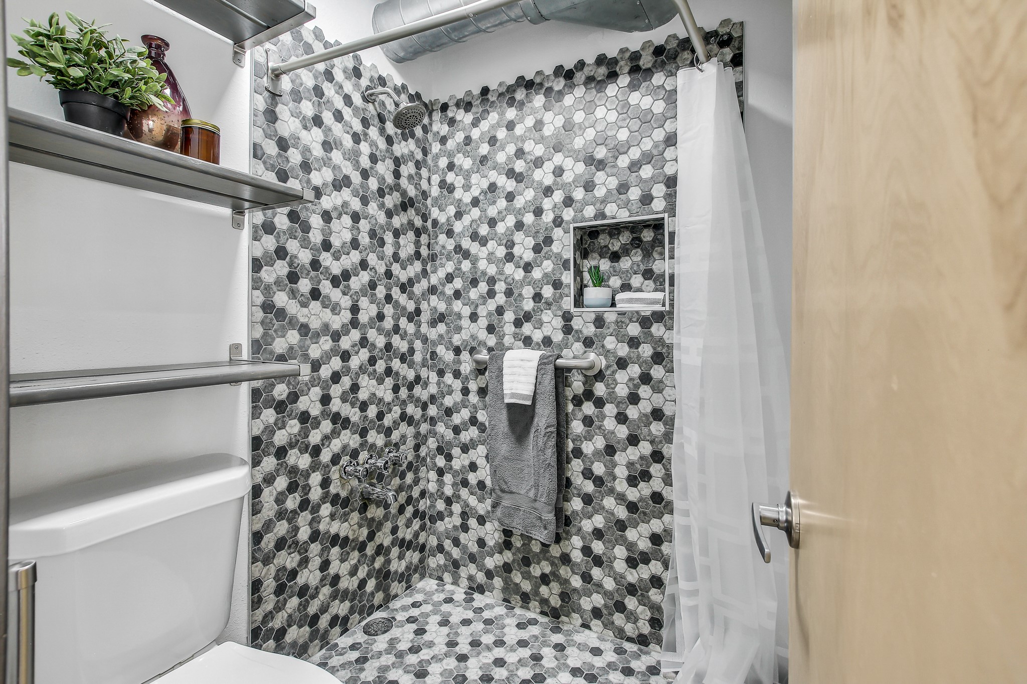 2124 Burton Drive, Unit 164 Austin, TX 78741 - Photo 19 of 37 a bathroom with a toilet and a shower curtain