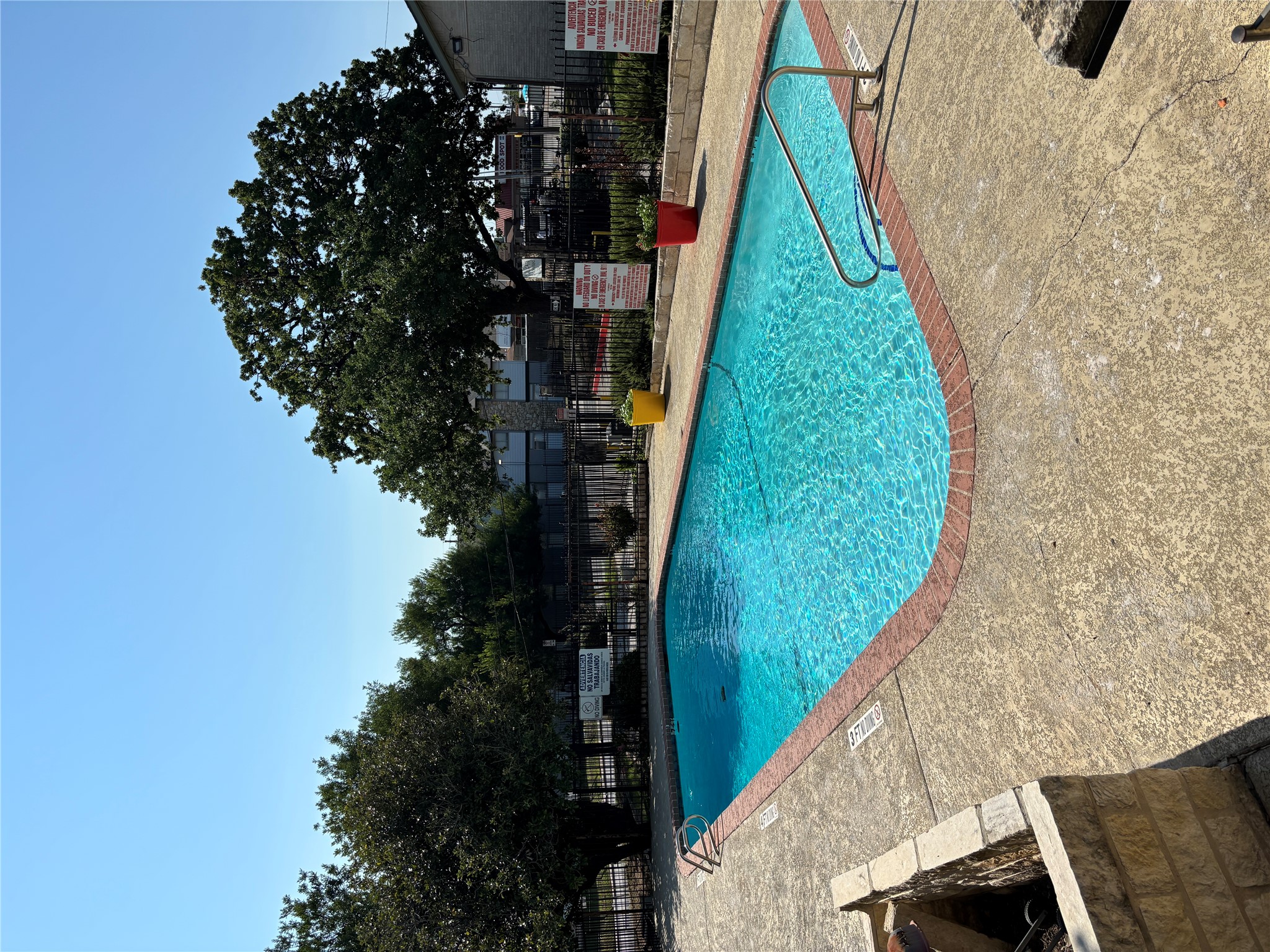 2124 Burton Drive, Unit 164 Austin, TX 78741 - Photo 26 of 37 a view of a swimming pool with a lounge chair