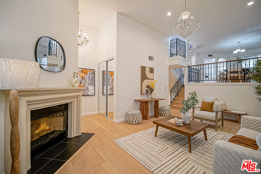 a living room with furniture a dining table and a fireplace