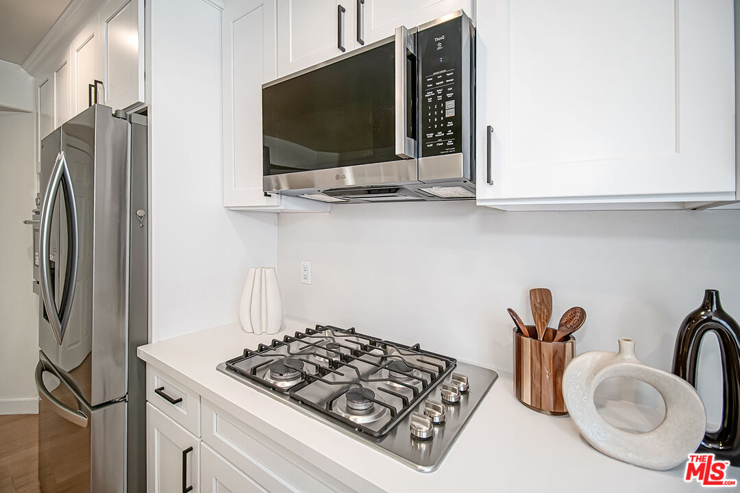 2950 South Bentley Avenue, Unit 3 Los Angeles, CA 90064 - Photo 14 of 32 a kitchen with stainless steel appliances granite countertop a sink and a stove