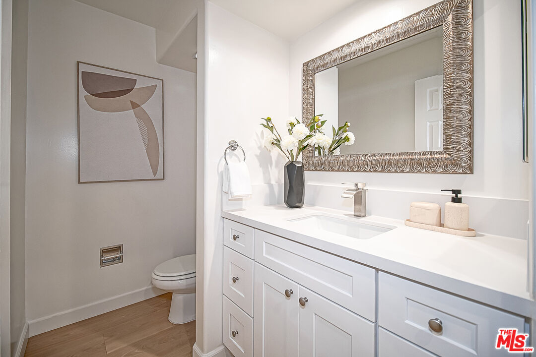 2950 South Bentley Avenue, Unit 3 Los Angeles, CA 90064 - Photo 16 of 32 a bathroom with a toilet sink and mirror