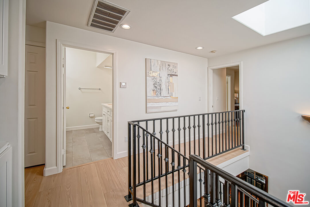 2950 South Bentley Avenue, Unit 3 Los Angeles, CA 90064 - Photo 17 of 32 a view of a hallway with windows
