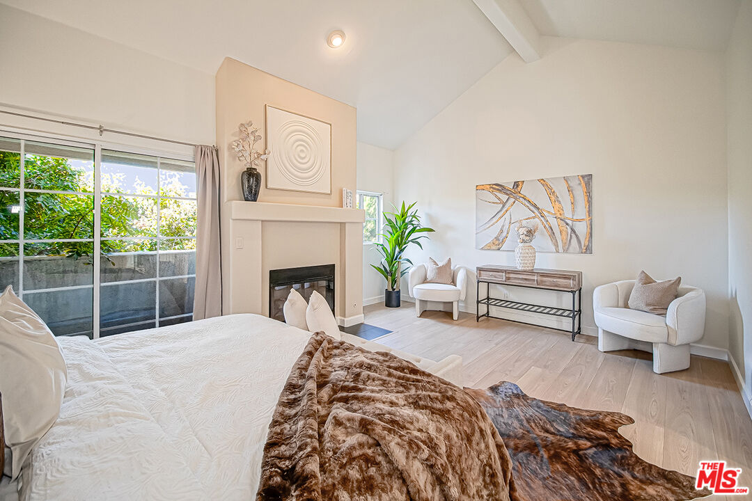 2950 South Bentley Avenue, Unit 3 Los Angeles, CA 90064 - Photo 20 of 32 a bedroom with furniture and a fireplace