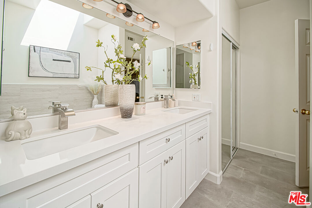 2950 South Bentley Avenue, Unit 3 Los Angeles, CA 90064 - Photo 25 of 32 a bathroom with double sink and a mirror