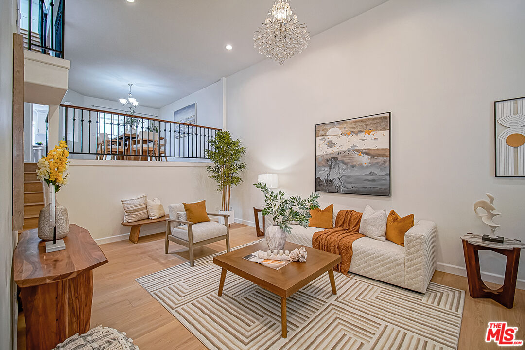 2950 South Bentley Avenue, Unit 3 Los Angeles, CA 90064 - Photo 3 of 32 a living room with furniture and a chandelier