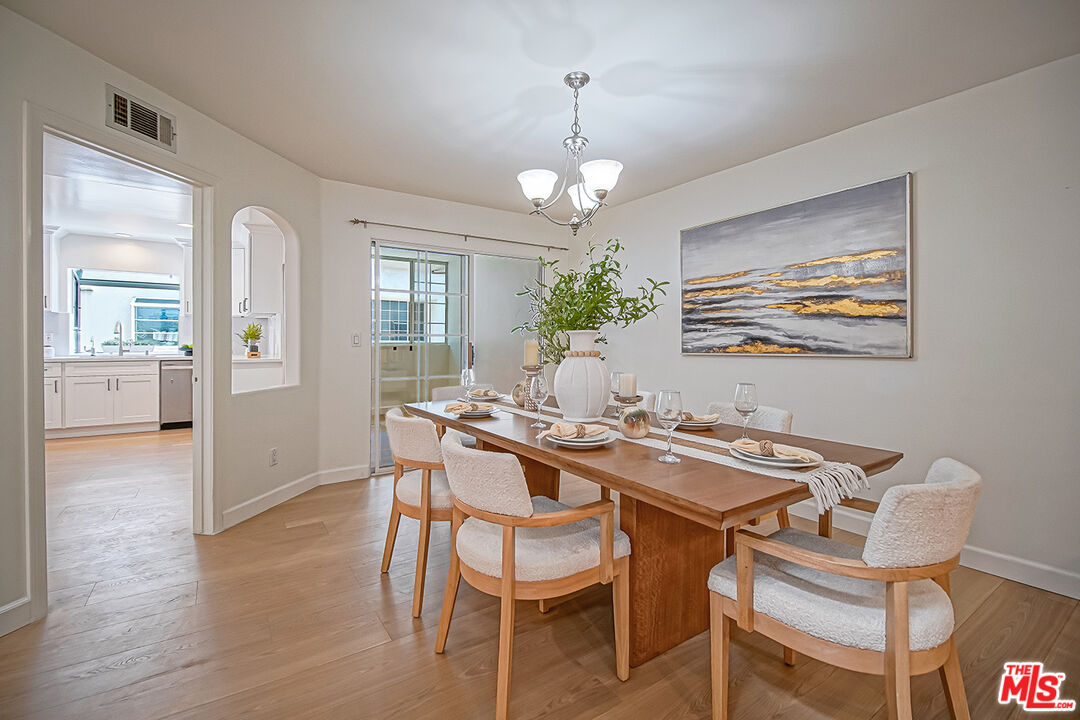 2950 South Bentley Avenue, Unit 3 Los Angeles, CA 90064 - Photo 6 of 32 a view of a dining room with furniture wooden floor and chandelier