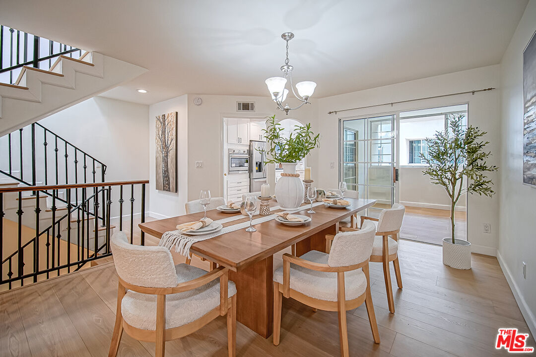 2950 South Bentley Avenue, Unit 3 Los Angeles, CA 90064 - Photo 7 of 32 a view of a dining room with furniture window and wooden floor