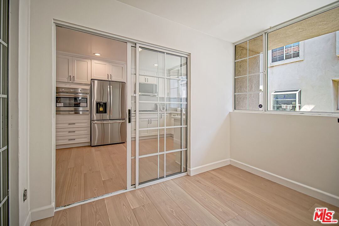2950 South Bentley Avenue, Unit 3 Los Angeles, CA 90064 - Photo 10 of 32 a view of a kitchen with wooden floor and refrigerator
