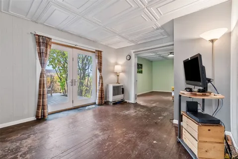 a view of work space with furniture and windows