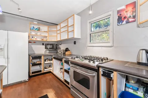 a kitchen with stainless steel appliances granite countertop a stove and a refrigerator