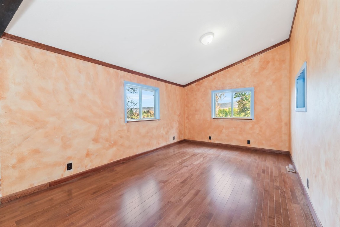 250 South Spruce Street Hayden, CO 81639 - Photo 17 of 46 an empty room with wooden floor and windows