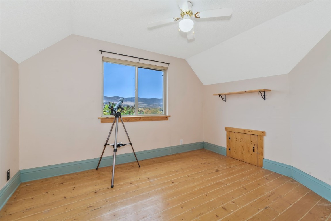 250 South Spruce Street Hayden, CO 81639 - Photo 31 of 46 a room with a chandelier fan and wooden floor