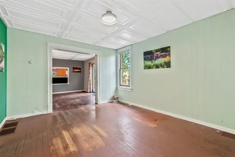 an empty room with windows and closet